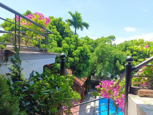 a balcony with flowers and plants on a building at Tam Coc Sunshine Homestay in Ninh Binh