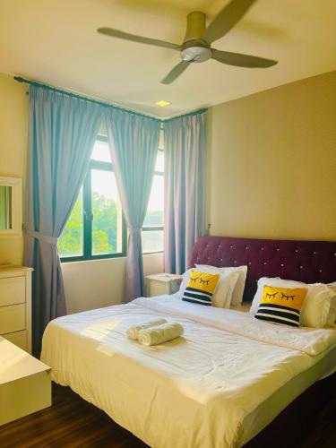 a bedroom with a large bed with blue curtains at RHFL Homestay Putrajaya in Putrajaya