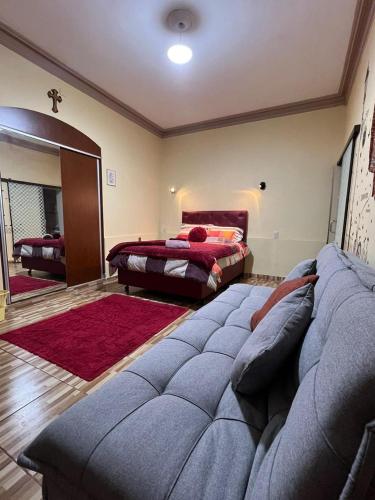 a living room with a couch and a bed at Arcángeles Guest House in Sucre