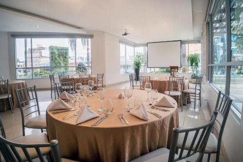 a conference room with a table with wine glasses at Wyndham Garden Guayaquil in Guayaquil