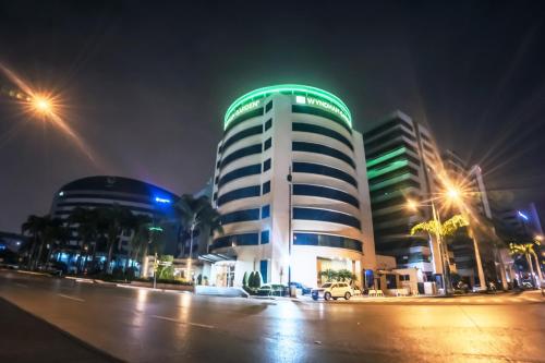 a building with a green dome on top at night at Wyndham Garden Guayaquil in Guayaquil