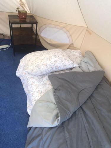 a pile of pillows on a bed in a tent at Checkpoint in Rosarito