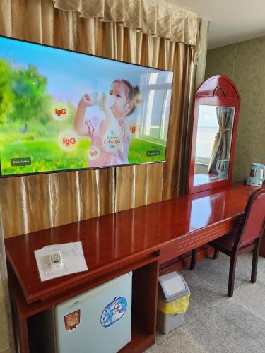 a flat screen tv sitting on top of a wooden table at Sea Light Hotel in Rach Gia