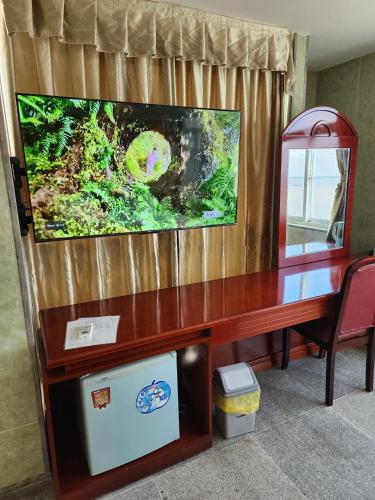 a wooden desk with a television on top of it at Sea Light Hotel in Rach Gia