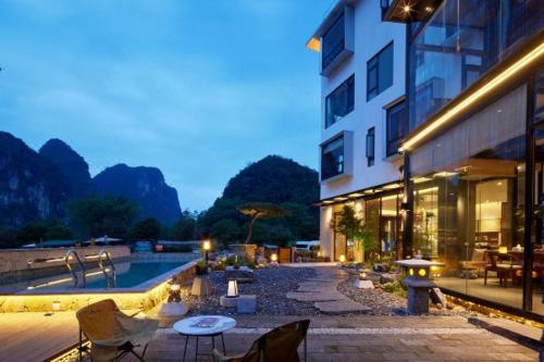 a building with a swimming pool next to a building at The One Hotel壹心生活美学酒店 in Yangshuo