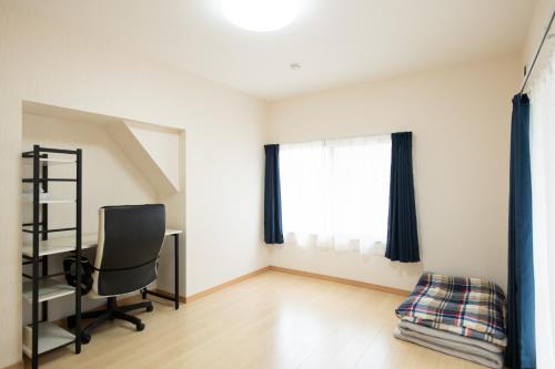 an empty room with a desk and a chair at Destiny Seaside Village in Sakaiminato