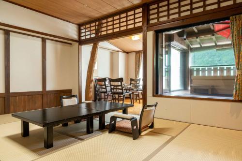 a dining room with a table and chairs and a window at Sasara in Gero