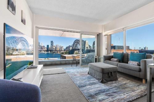 a living room with a view of the sydney harbour at Dream Views of Sydney CBD in Sydney
