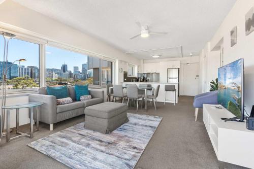 a living room with a couch and a table at Dream Views of Sydney CBD in Sydney