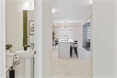 baño con lavabo y cocina con mesa. en NEW- Falls Serenity Sanctuary, en Thorold