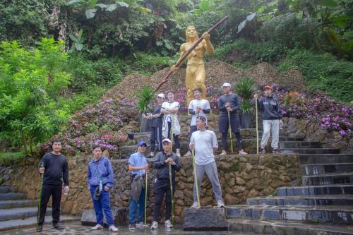 a group of people standing in front of a statue at Khu Du Lịch Tea Bobla Waterfall in Di Linh