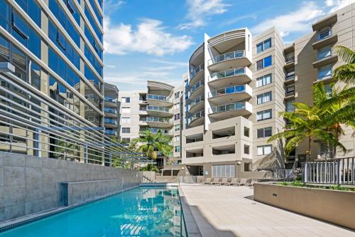 an apartment complex with a swimming pool and buildings at Allegro Apartments in Brisbane