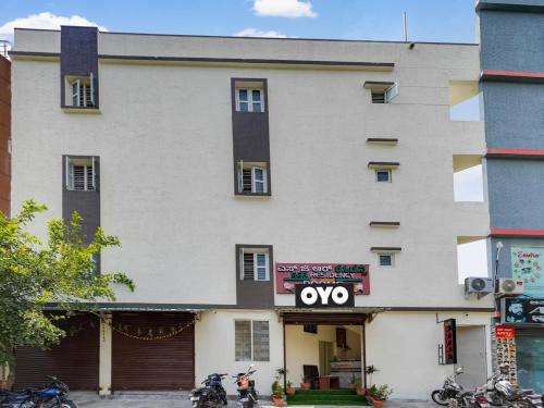 a large white building with a sign on it at Hotel O SGR Residency in Bengaluru