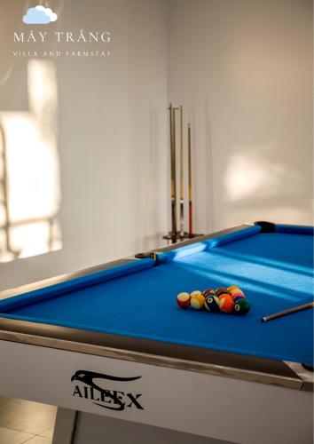 a pool table with balls on top of it at Mây Trắng Villa and FarmStay in Ba Vì