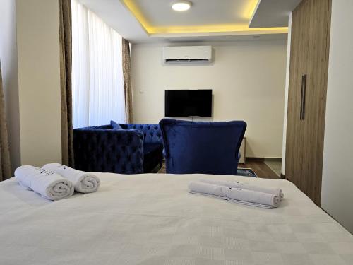 a hotel room with a bed with towels on it at Nurel Shark Residence in Kérynia