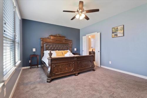 a bedroom with a bed and a ceiling fan at The Aubrey Escape with Fenced Backyard in Aubrey