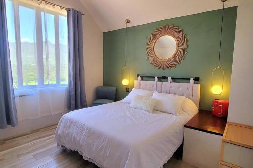 a bedroom with a white bed and a mirror at Cabaña Gepetto in Cardonal