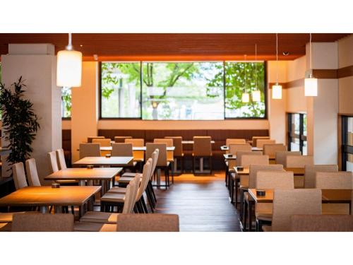 a dining room with tables and chairs and a large window at Kutsurogi no Yado Juraku - Vacation STAY 03506v in Tobe
