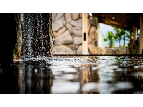 a water fountain in front of a building at Kutsurogi no Yado Juraku - Vacation STAY 03506v in Tobe