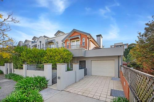 a large house with a fence and a driveway at Family 3BR 2-level Home at Central Chatswood in Sydney