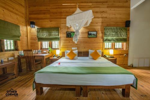 a bedroom with a bed in a room with wooden walls at The Other Corner Habarana in Habarana