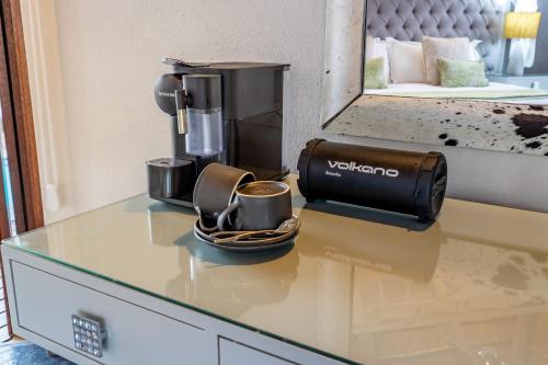 a coffee machine sitting on a counter with a cup of coffee at Kusudalweni Safari Lodge and Spa in Guernsey Nature Reserve