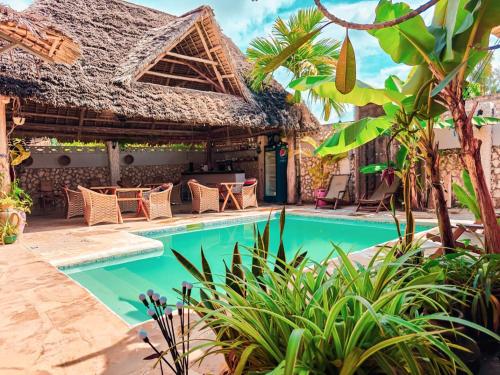 a villa with a swimming pool in a resort at Nungwi Roses in Nungwi