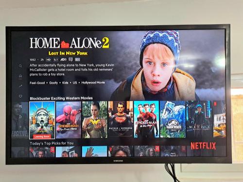 a television screen with a picture of a movie at Go-Vitug Apartell, 2-8 pax, AC, Netflix, Parking in Olongapo