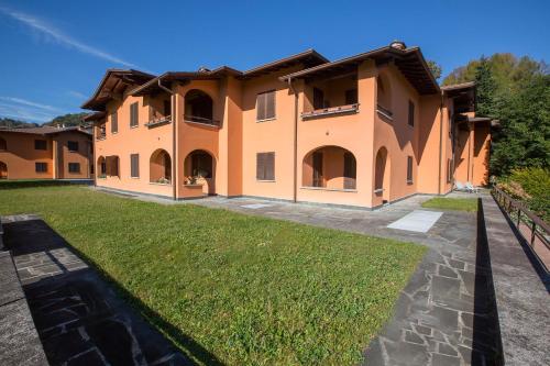 a large house with a lawn in front of it at Menaggio Poggio Fiorito Loggetta in Menaggio