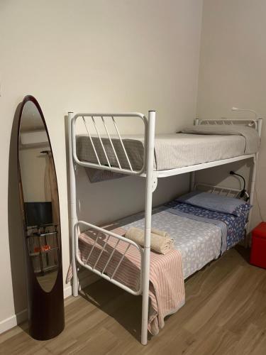a room with two bunk beds and a mirror at Casa Vacanze “Bouganville” loc Avane Pisa in Vecchiano