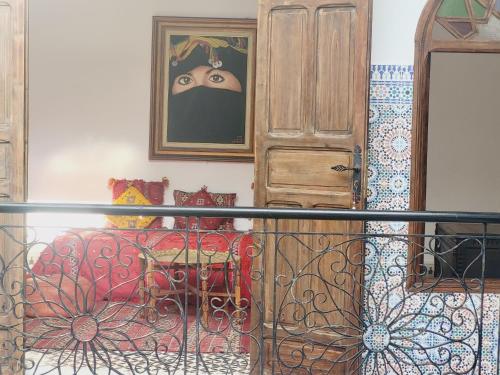 a bedroom with a bed and a painting on the wall at Riad Dar Nawfal in Sale