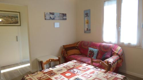 a living room with a couch and a table at Casa Vacanze “Bouganville” loc Avane Pisa in Vecchiano
