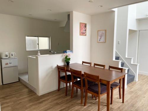 a kitchen and dining room with a table and chairs at QUAYSIDE SAKURAGICHO 401 in Yokohama