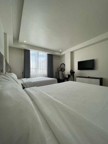 Кровать или кровати в номере Lotus Hotel & Apartment