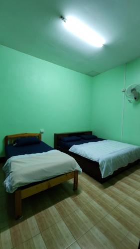 Postel nebo postele na pokoji v ubytování JaiSabai Homestay