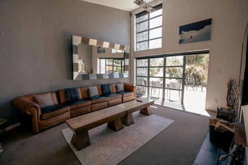 a living room with a couch and a table at Casa Del Caird in Methven
