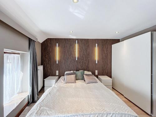 a bedroom with a large white bed in a room at Le relais des Forges in Sprimont