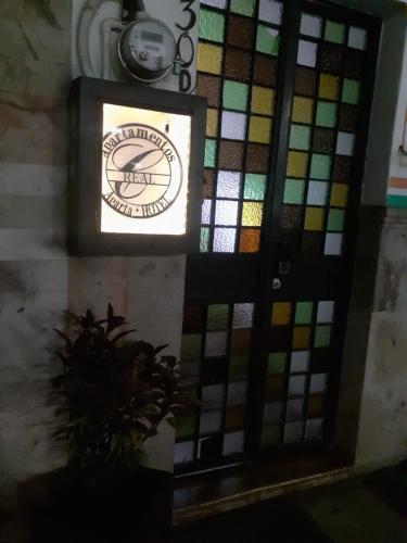 a door with a stained glass window on a wall at Aparta-Hotel CASA REAL Apartamentos in Chapala