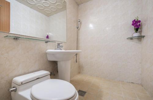 a bathroom with a toilet and a sink at Apple Hotel in Jeju