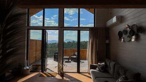 a living room with a large window and a couch at Nebo Shale in Yablunytsya