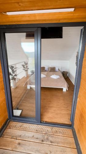 a view of a bedroom through a glass window at Nebo Shale in Yablunytsya