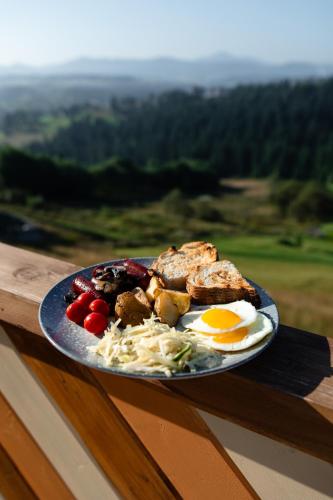 a plate of food with eggs and vegetables on a table at Nebo Shale in Yablunytsya
