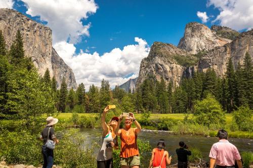 a group of people playing frisbee in a river at Evergreen Lodge at Yosemite in Groveland
