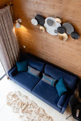a room with a blue couch with stuffed animals on the wall at Nebo Shale in Yablunytsya