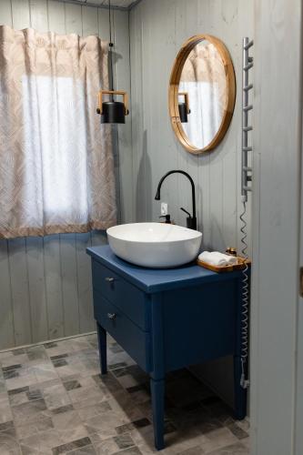 a bathroom with a blue sink and a mirror at Nebo Shale in Yablunytsya