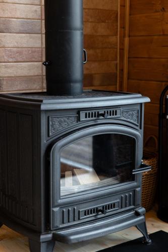 a black stove sitting inside of a room at Nebo Shale in Yablunytsya
