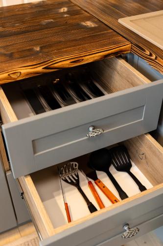 a drawer in a kitchen with utensils in it at Nebo Shale in Yablunytsya