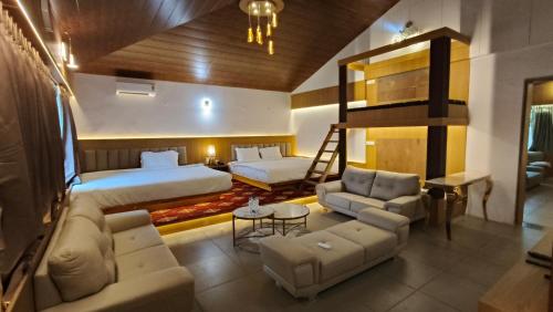 a hotel room with a bed and a loft at Urmilaa Green County Resort 35 KM From Kolhapur in Kolhapur