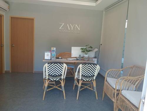a room with a table and two chairs and a table and a table at ZAYN Samui Hotel in Bophut 