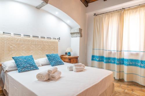 a bedroom with a bed with towels on it at PV9 by DomusAway in Olbia